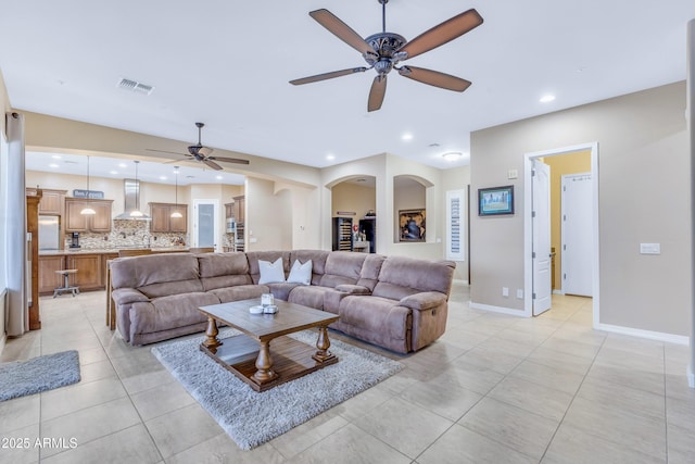 living room with light tile patterned flooring and ceiling fan