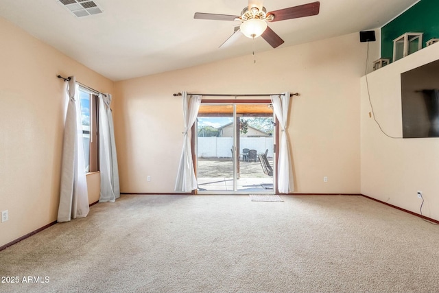 carpeted spare room featuring lofted ceiling and ceiling fan