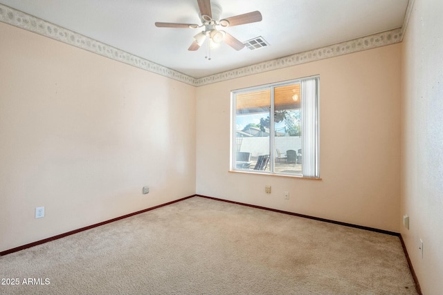 empty room featuring light carpet and ceiling fan