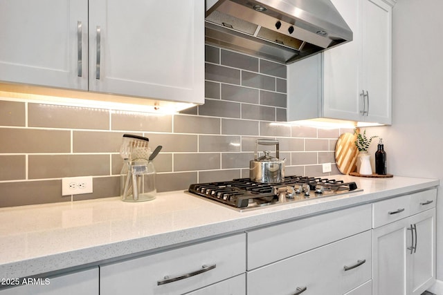 kitchen featuring backsplash, white cabinets, extractor fan, and stainless steel gas stovetop