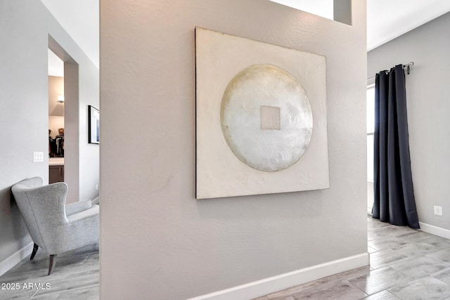 interior space with baseboards and wood finished floors