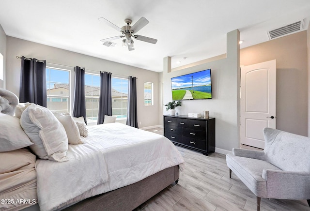 bedroom with visible vents, light wood-style flooring, baseboards, and ceiling fan