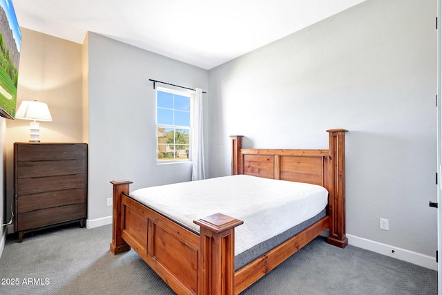 bedroom featuring baseboards and carpet