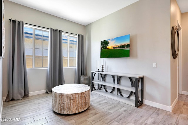 interior space with baseboards and light wood-type flooring