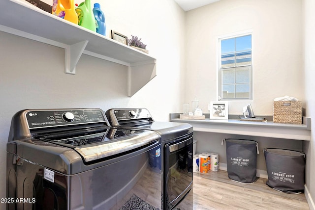 laundry room featuring laundry area, independent washer and dryer, and light wood-type flooring