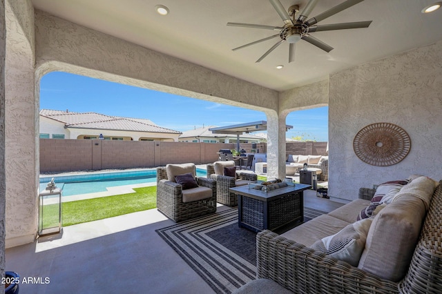 view of patio featuring an outdoor hangout area, a ceiling fan, a fenced in pool, and a fenced backyard