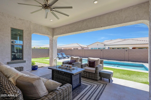 view of patio featuring a fenced backyard, a ceiling fan, a fenced in pool, and an outdoor living space
