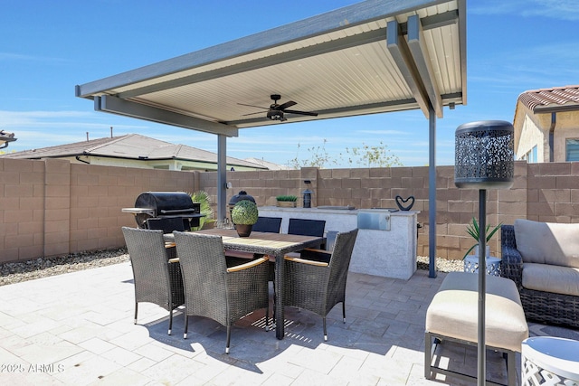 view of patio featuring outdoor dining area, a fenced backyard, ceiling fan, and a grill