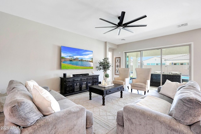 living area with visible vents and ceiling fan