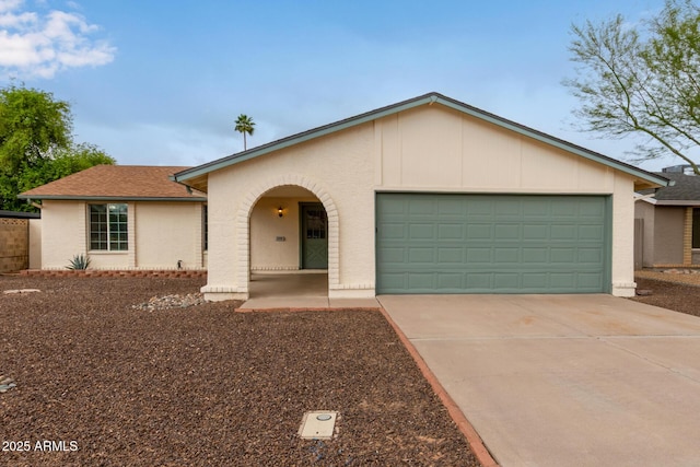 view of front of home with a garage, driveway, and roof with shingles