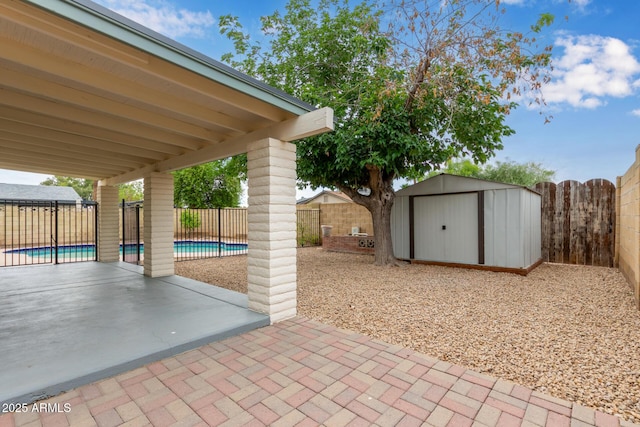 view of patio / terrace featuring a shed, an outbuilding, and a fenced backyard