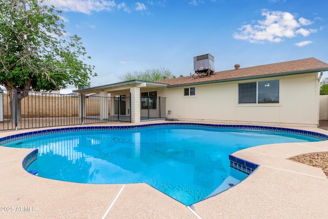 view of pool featuring central AC unit and fence