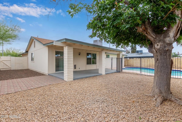 rear view of house featuring a patio area and a fenced backyard