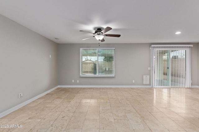 spare room with a ceiling fan, plenty of natural light, recessed lighting, and baseboards
