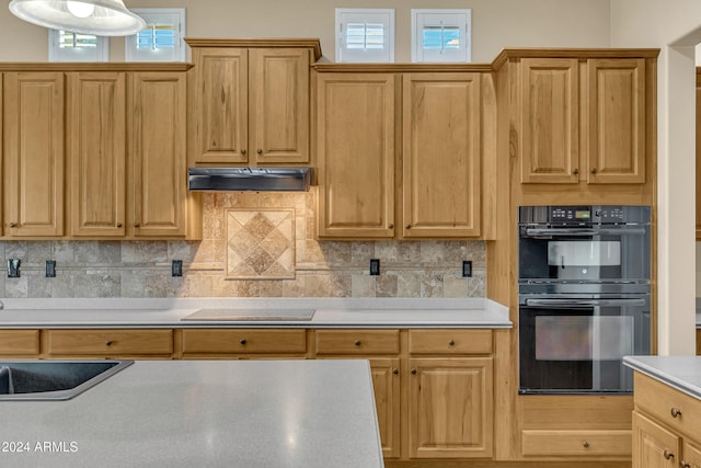 kitchen featuring plenty of natural light, black appliances, and decorative backsplash