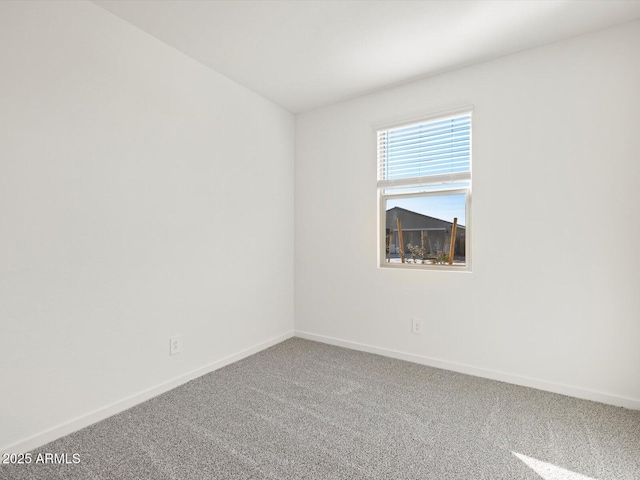 carpeted empty room with baseboards