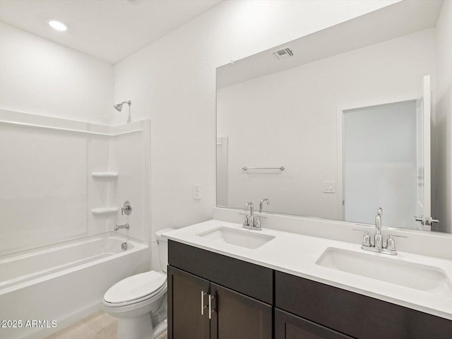 full bathroom with double vanity, shower / bath combination, a sink, and toilet