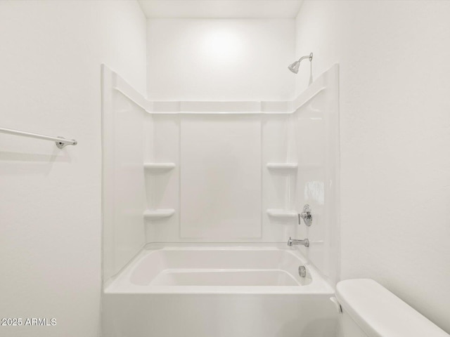 bathroom with toilet and bathing tub / shower combination