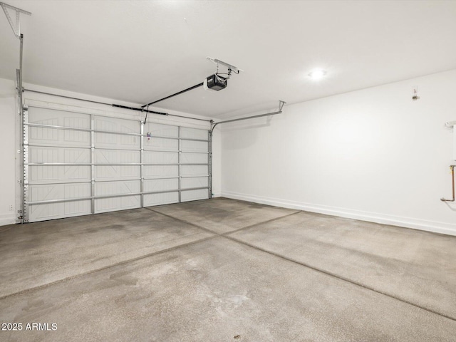 garage with baseboards and a garage door opener