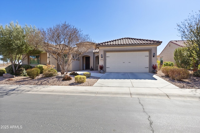 view of front of property with driveway, an attached garage, and stucco siding