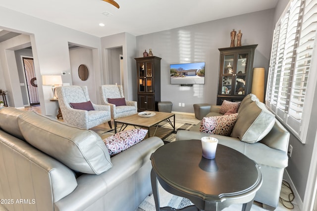 living area featuring recessed lighting, baseboards, and wood finished floors