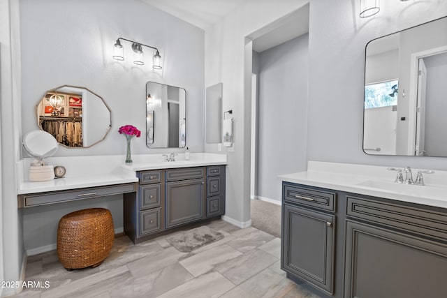 bathroom featuring two vanities and a sink