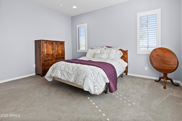 carpeted bedroom featuring baseboards