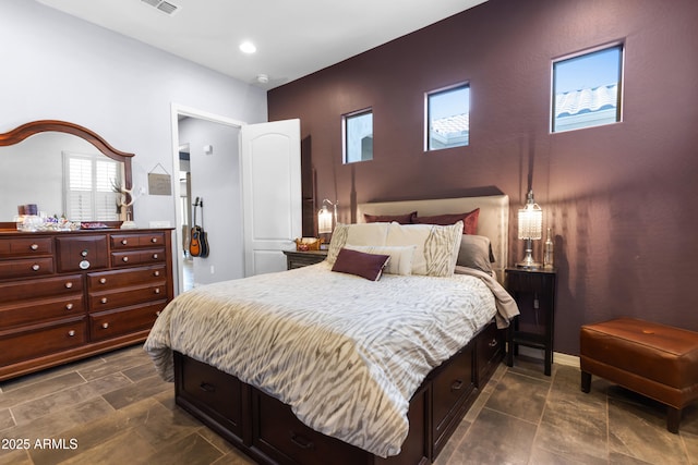 bedroom featuring visible vents and baseboards