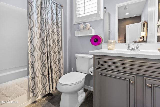 bathroom with baseboards, vanity, toilet, and shower / tub combo with curtain