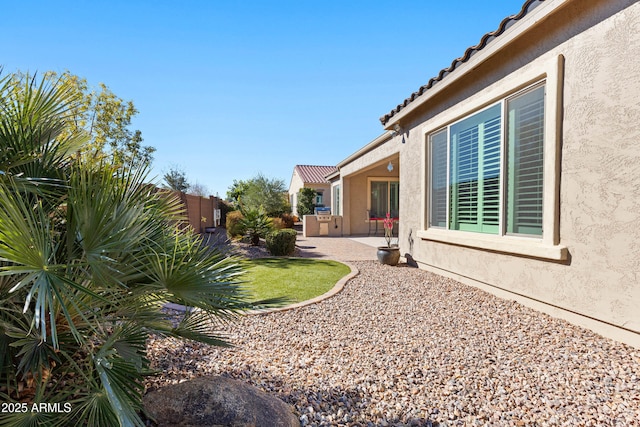 view of yard with fence and a patio