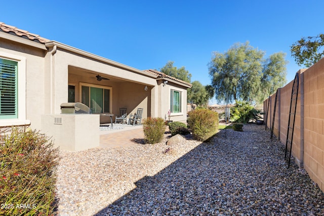 view of yard with ceiling fan, a patio, and a fenced backyard