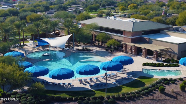 pool featuring fence, a water slide, and a patio