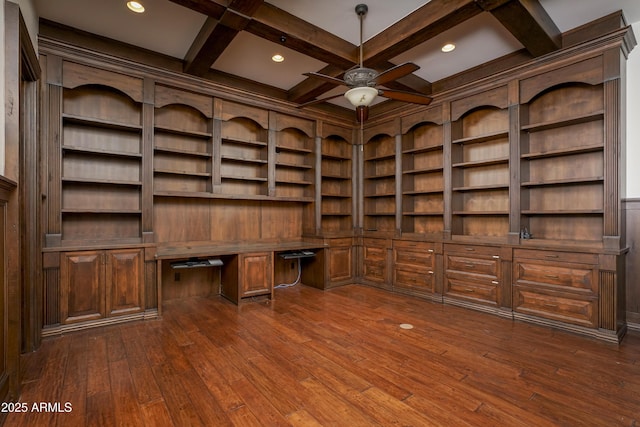 unfurnished office with built in shelves, dark wood-type flooring, coffered ceiling, beamed ceiling, and built in desk