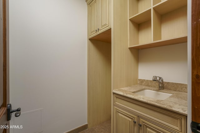 clothes washing area featuring sink