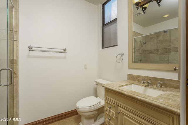 bathroom featuring tile patterned flooring, vanity, toilet, and walk in shower