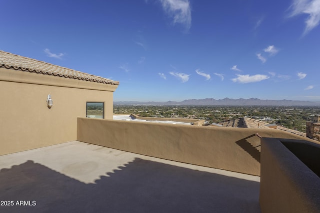 view of patio featuring a mountain view and a balcony