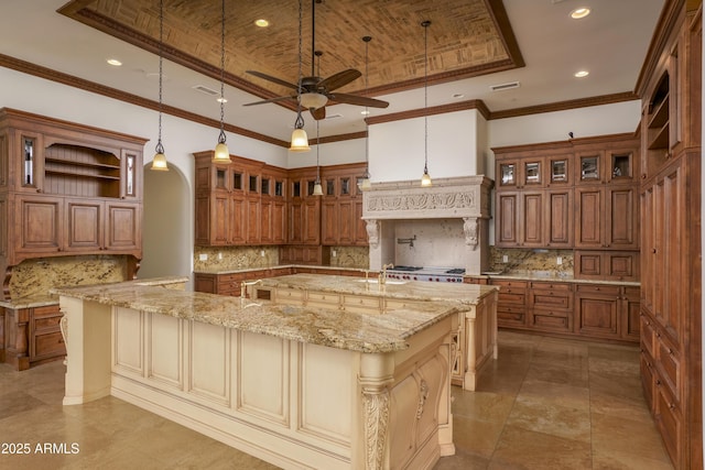 kitchen featuring backsplash, a large island, hanging light fixtures, and ornamental molding