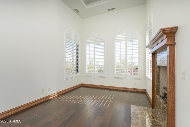 unfurnished room with dark hardwood / wood-style floors and a fireplace