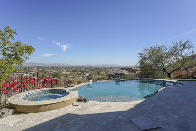 view of pool with a patio area, a mountain view, and an in ground hot tub