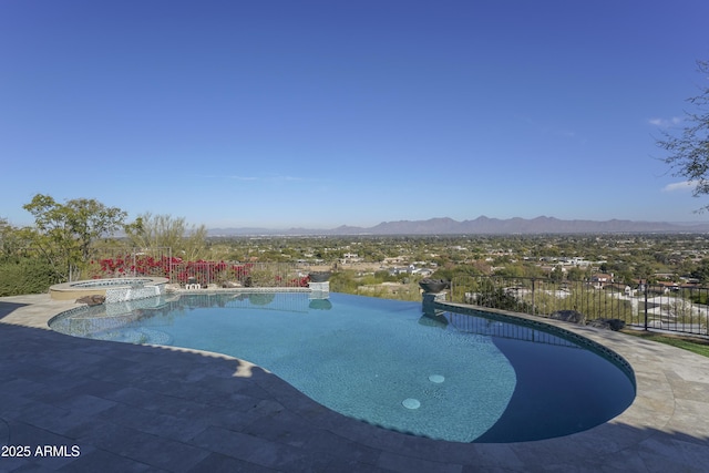 view of swimming pool featuring a mountain view and an in ground hot tub