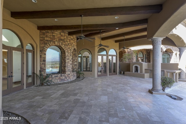 view of patio / terrace with ceiling fan, french doors, and an outdoor fireplace