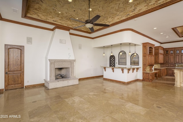 unfurnished living room featuring ceiling fan, lofted ceiling, brick ceiling, a fireplace, and ornamental molding