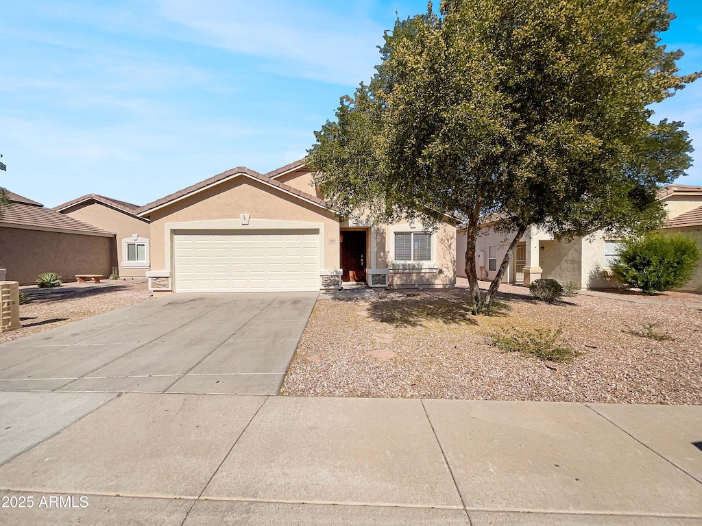 1595 S 227th Ave, Buckeye, AZ 85326 - view of front of house featuring a garage, stucco siding, and driveway