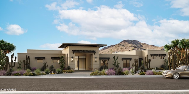 view of front of home with a mountain view and stucco siding