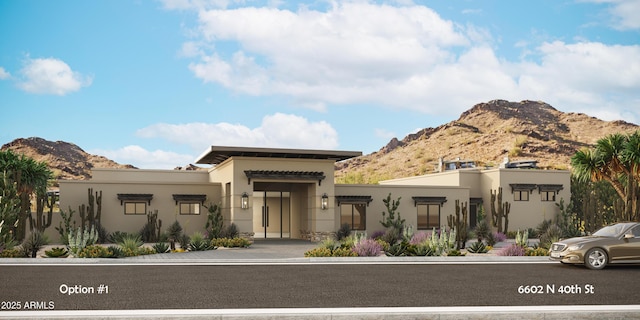 view of front of home with a mountain view and stucco siding