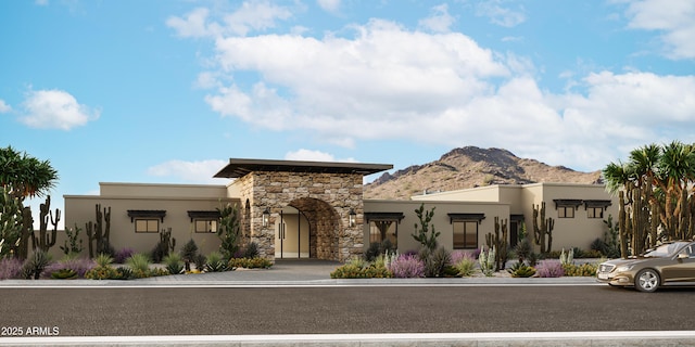 view of front of property with stone siding, a mountain view, and stucco siding