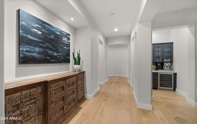 hallway featuring wine cooler and light wood-type flooring