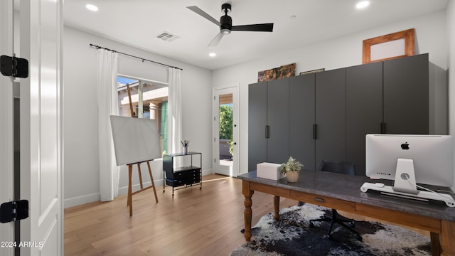 office with light hardwood / wood-style floors and ceiling fan