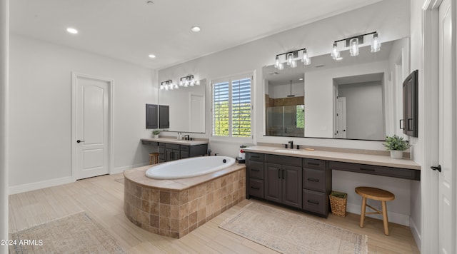 bathroom with vanity, hardwood / wood-style flooring, and separate shower and tub