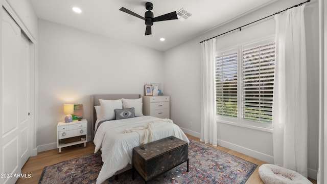 bedroom featuring hardwood / wood-style flooring, a closet, and ceiling fan